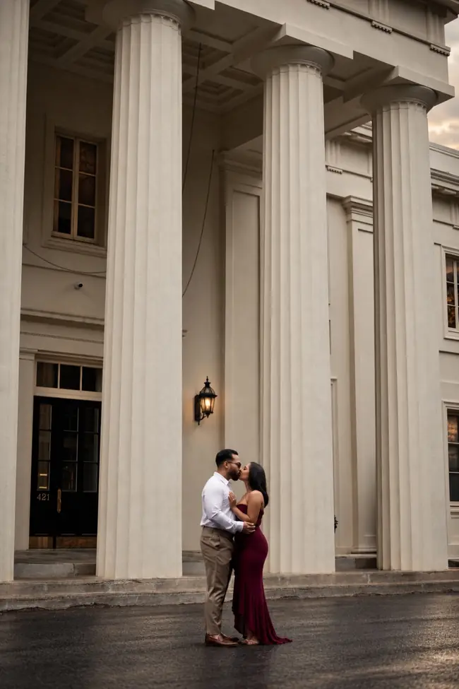 Couple standing beneath classical columns